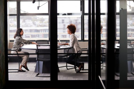 two millennial businesswomen meeting for a job interview managing interview anxiety